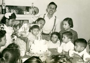 Amado Beltrán y su esposa Celestina en la celebración del segundo aniversario de su hija, los niños atentos al soplido de las velas. Fotógrafo García Cano, Fototeca Lorenzo Becerril A.C.